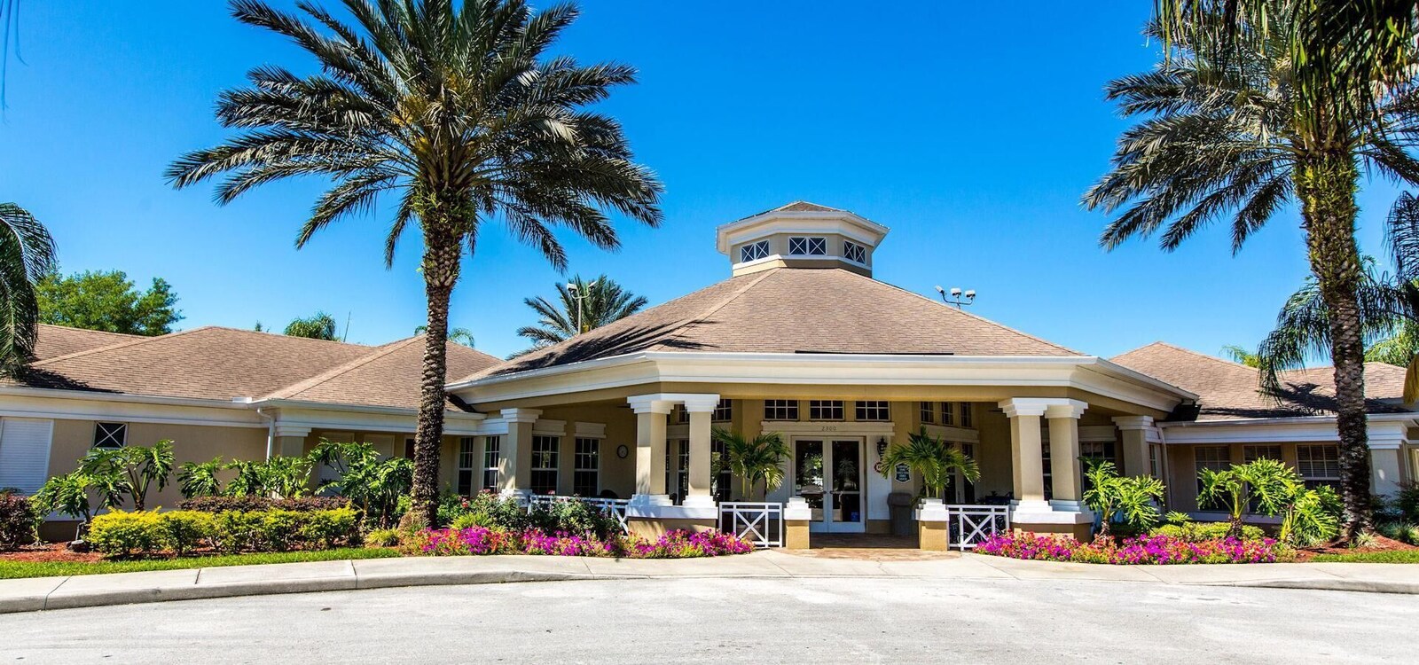 The two-storey Windsor Palms vacation home with palm trees outside